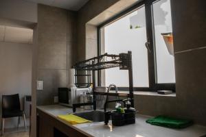 a kitchen with a sink and a window at Hostel Las Pibas in Sarmiento