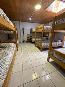 a room with several bunk beds and a tile floor at Residencial Don Santiago in Talca