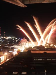 a firework display over a city at night at La soledad in Oaxaca City