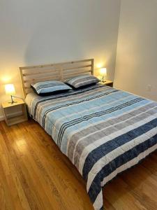 a bedroom with a bed with two pillows on it at Remarkable 3 Room Apt Close to NYC in Jersey City
