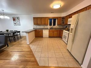 a kitchen with a refrigerator and a table in it at Remarkable 3 Room Apt Close to NYC in Jersey City