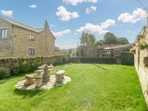 a garden with a stone bench in a yard at 2 Bed in Rowlands Gill 89758 in Stanley