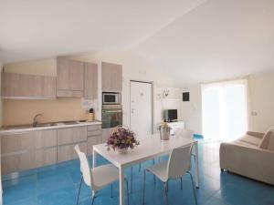 cocina y sala de estar con mesa y sillas en Residence Abruzzo Resort, en Tortoreto Lido