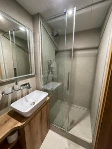 a bathroom with a sink and a shower at UnderStreet studio with private parking in Košice