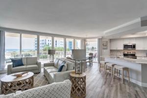 a living room with a couch and a table at St Maarten 308 a Renovated Luxury Beach Front 3 Bedroom 3rd Floor Condo with Resort Amenities in Destin