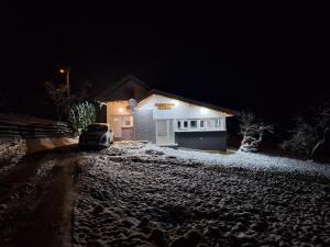 a car parked in front of a house at night at Vikendica Avram-Plane 