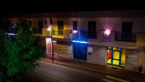 a building with lights on the side of it at night at Erania Apartments in Sala Consilina