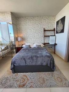 a bedroom with a large bed and a rug at Toreo, polanco. in Mexico City