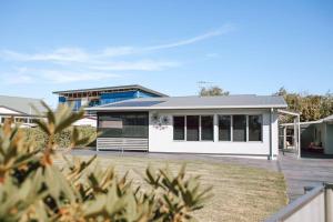 a white house with a lot of windows at Mara House - Space for Everyone in St Helens