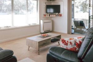 a living room with a couch and a coffee table at Mara House - Space for Everyone in St Helens