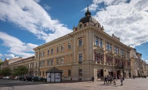 a large building with people walking in front of it at UnderStreet studio with private parking in Košice