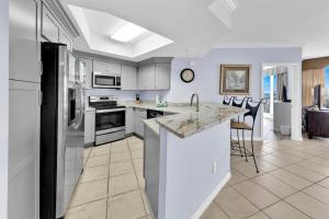 a kitchen with white cabinets and a counter top at St Maarten 402 a Luxury Beachfront 3 Bedroom Condo Elevator Opens Into Unit in Destin