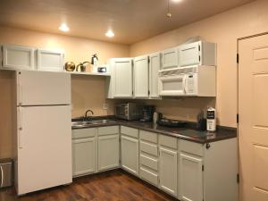 a kitchen with white cabinets and a white refrigerator at Mountain View Apartment, Residential Area, Private Entrance in Sedona