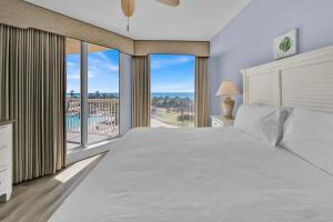 a bedroom with a large bed and a large window at St Maarten 402 a Luxury Beachfront 3 Bedroom Condo Elevator Opens Into Unit in Destin