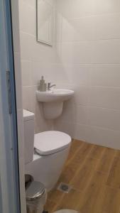 een witte badkamer met een toilet en een wastafel bij Slivnitsa 105 in Varna