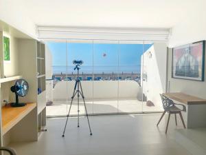 a camera on a tripod in a room at Radazul Seafront Marina 9 in Radazul
