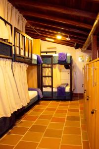 a room with two bunk beds and a floor at Hostal Colombian Gold in San Gil