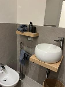 a bathroom with a white sink and a toilet at Casa Rosina agli Scavi Parcheggio Privato Incluso in Ercolano +16 photos