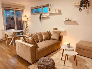 a living room with a couch and a table at charmant in Noisy-le-Sec