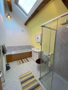 a bathroom with a shower and a sink and a tub at Langway in Gatebeck
