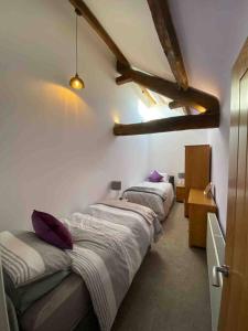 a bedroom with three beds in a room at Langway in Gatebeck