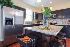 a kitchen with a large stainless steel refrigerator at The Venice Oasis - 4BR-3BA 16 Guests in Atlantic City