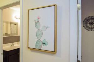 a picture of a cactus on a wall in a bathroom at The Venice Oasis - 4BR-3BA 16 Guests in Atlantic City