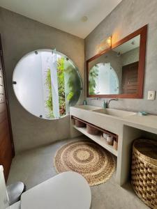 a bathroom with a sink and a mirror at La reserve villa tropicana in Pipa