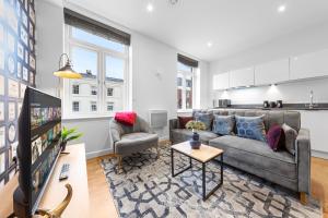 un soggiorno con divano e TV di Stylish One Bedroom Flat - Sleeps 3 - Near Heathrow, Windsor Castle, Thorpe Park - Staines London TW18 a Staines upon Thames