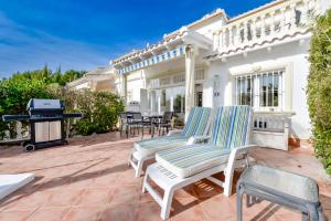 a patio with two lounge chairs and a grill at Bungalow Casa Romero in Calpe, Spain in Calpe