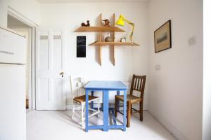 a kitchen with a blue table and two chairs at Clara Vale Farm House Retreat in Rathdrum