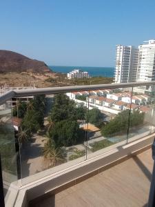 a balcony with a view of the beach and buildings at Salguero suites resort in Gaira