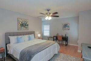 a bedroom with a bed and a ceiling fan at Bartram Dream House II - Bartram Beach Retreat in Atlantic City