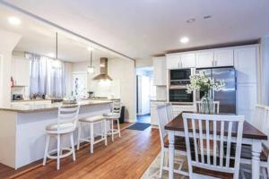 a kitchen and dining room with a table and chairs at Luxe Bartram Beach Retreat 4BD - 3BA in Atlantic City