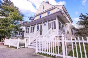 una cerca blanca frente a una casa blanca en Luxe Bartram Beach Retreat 4BD - 3BA, en Atlantic City