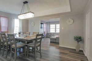 a dining room and living room with a table and chairs at Escape to Raleigh Ave Glamour - Steps to the Beach in Atlantic City