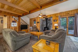 a living room with couches and a tv at Dragonfly Lodge in Arnold