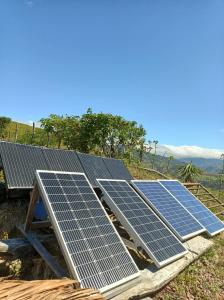 a group of solar panels on top of a house at Sustainable, Off-Grid and Organic Cabins on a Farm in a Secluded Cloud Forest, Ultra Low Carbon Footprint in Puntarenas