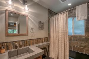 a bathroom with a sink and a window at Arnold Schwartzencabin in Arnold +37 photos