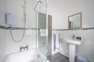 a white bathroom with a shower and a sink at *RA9GH* For your most relaxed & Cosy stay + Free Parking + Free Fast WiFi * in Bramley