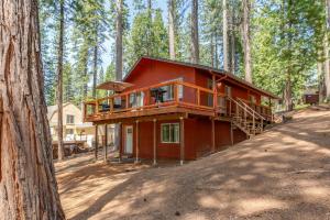 a red house in the middle of a forest at The Ponderosa Paddle in Arnold
