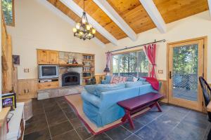 sala de estar con sofá azul y chimenea en Candys Cottage, en Camp Connell