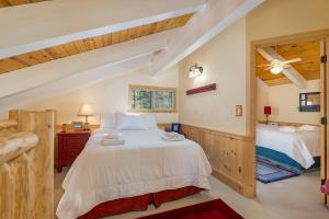 a bedroom with a large white bed and a window at Candys Cottage in Camp Connell