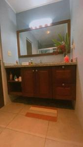 a bathroom with a sink and a large mirror at Casa Gato in Big Creek