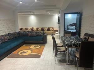 a living room with a blue couch and a table at دار صوفيا in Fez