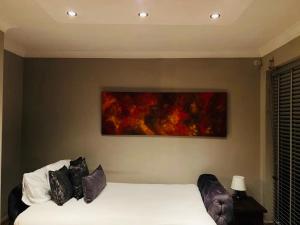 a bedroom with two beds and a painting on the wall at Twilight in London