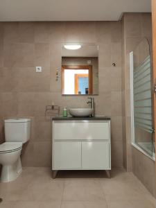 uma casa de banho com um lavatório, um WC e um espelho. em Apartamento La Torre Golf em Torre-Pacheco