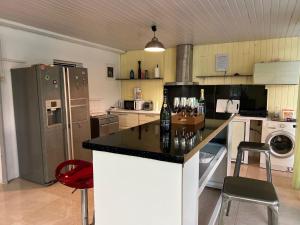 a kitchen with a counter with a bottle of wine on it at Villa BEAUCI-TURLET in Goyave