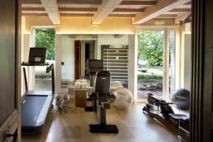 a room with a salon with a chair in it at Hotel Château Des Alpilles in Saint-Rémy-de-Provence