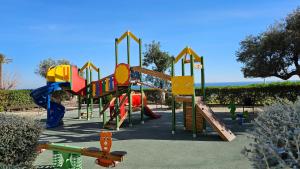 a playground with a slide in a park at TERRAMAR sweet home in Villajoyosa